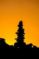 Stacked stones at sunset photo