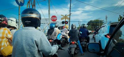 vehicles stop at the railroad crossing, Semarang, Indonesia March 2023 photo