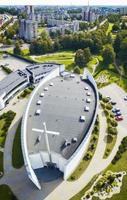 Beautiful and modern Siauliai church in southern part of the city from aerial perspective. Siauliai City buildings on the background photo