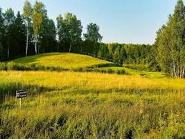 Typical mounds in summer Lithuania countryside. Famous formation to visit in tranquil countryside Baltics photo