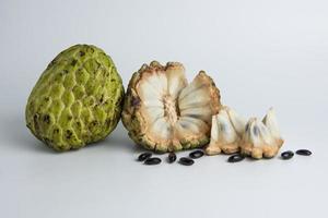 sugar apple srikaya with black spots, isolated on a white background, sugar apple fruit tastes sweet, grows in the tropics, can be eaten directly when it is ripe or can be processed first. photo