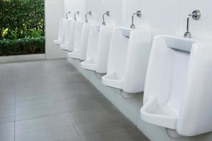Urinals men in public toilet photo
