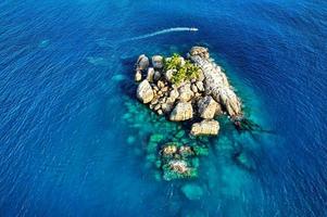 L'ilot island and passing boat, Mahe Seychelles photo