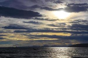 Tropical paradise sunset turquoise water beach limestone rocks Krabi Thailand. photo