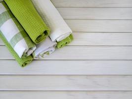 A pile of neatly folded towels on wooden background. Production of natural textile fibers.Organic product. Natural cloth photo