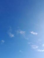 Beautiful white clouds on deep blue sky background. Large bright soft fluffy clouds are cover the entire blue sky. photo