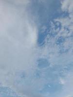 Beautiful clouds on deep blue sky background. Large bright soft fluffy clouds are cover the entire blue sky. photo