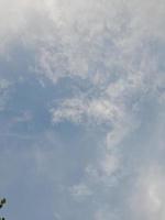 Beautiful clouds on deep blue sky background. Large bright soft fluffy clouds are cover the entire blue sky. photo