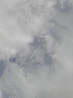 Beautiful clouds on deep blue sky background. Large bright soft fluffy clouds are cover the entire blue sky. photo