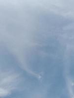 Beautiful white clouds on deep blue sky background. Large bright soft fluffy clouds are cover the entire blue sky. photo