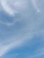 Beautiful white clouds on deep blue sky background. Large bright soft fluffy clouds are cover the entire blue sky. photo