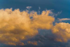 Thunderstorm clouds illuminated by disappearing rays at sunset, thunderclouds floating across sky to change weather. Abstract meteorology background. photo