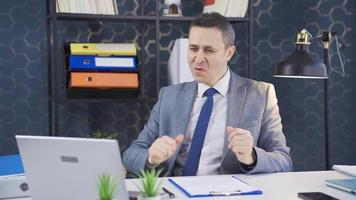 Happy businessman working on laptop in his office. Male executive dancing happily and joyfully in his office, full of life and positive. video