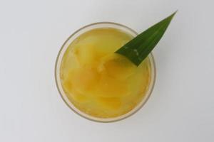 glass of Candied Carica or Manisan Carica. photo