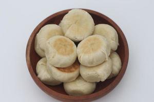 a close up of Bakpia served in a wooden bowl photo