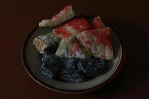 sengkulun, cenil, and getuk served on a plate and ready to eat. photo