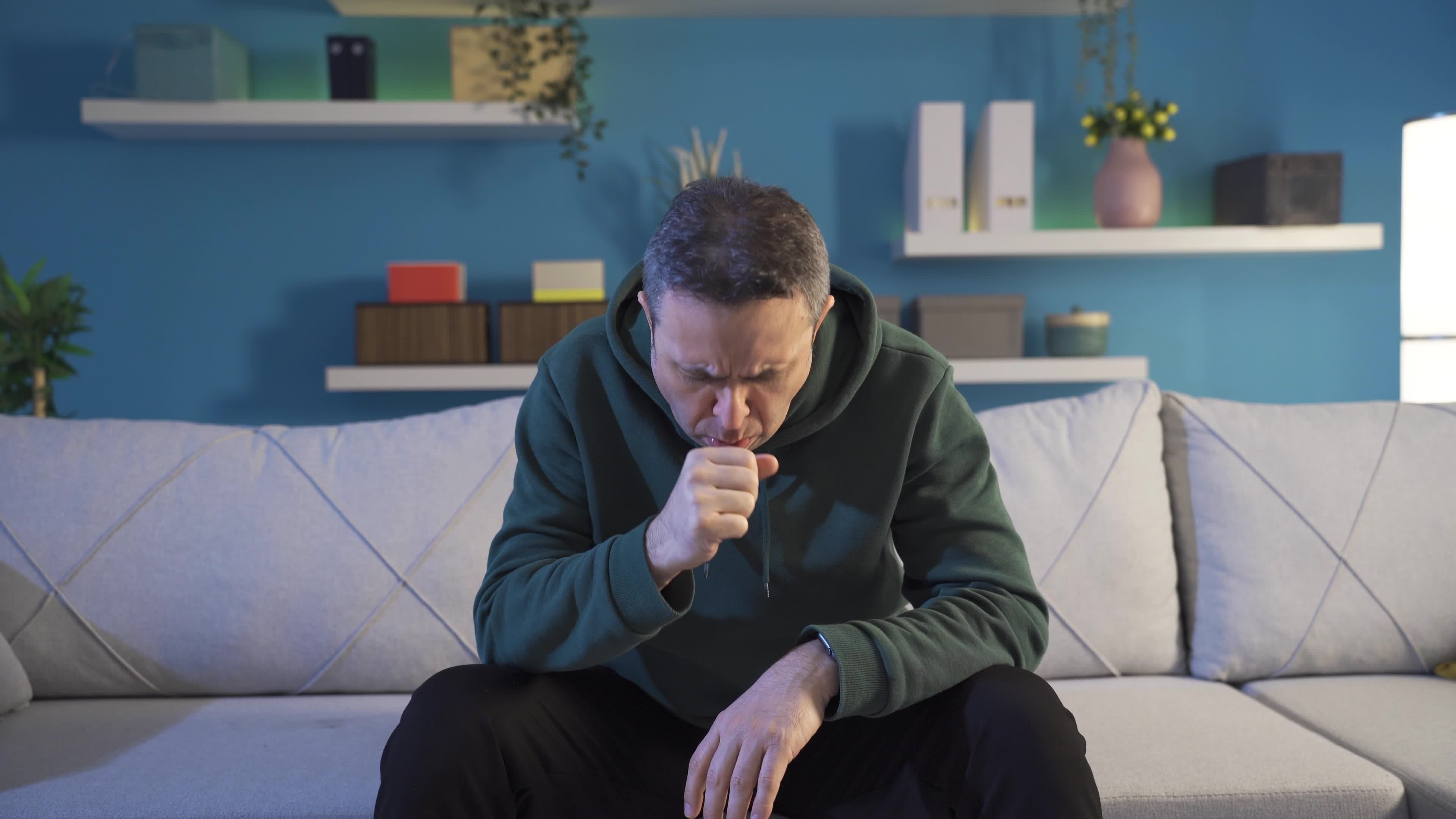 Sick man coughing at home, having dangerous virus, poor health. Sick