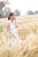 Young Asian women  in white dresses  in the Barley rice field photo