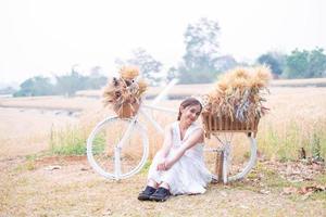 Young Asian women  in white dresses  in the Barley rice field photo