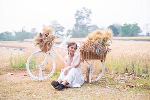 Young Asian women  in white dresses  in the Barley rice field photo