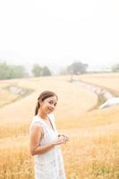 Young Asian women  in white dresses  in the Barley rice field photo