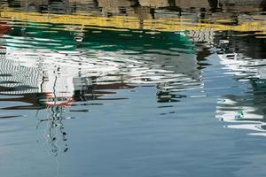 Nautical vessels reflected on water. Iceland photo