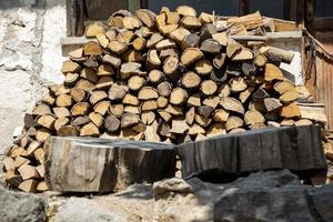 A pile of firewood in the yard of a country house. a pile of birch logs. photo