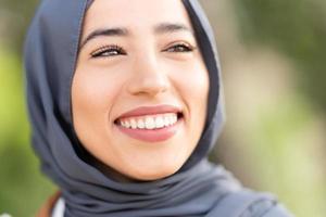 Attractive muslim woman smiling with a relaxed expression photo