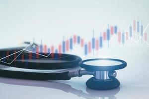 Stethoscope and financial graph, healthcare business. photo