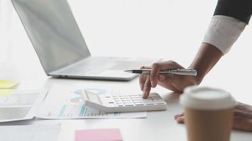 Financial analysts analyze business financial reports on a digital tablet planning investment project during a discussion at a meeting of corporate showing the results of their successful teamwork. video