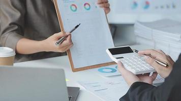Financial analysts analyze business financial reports on a digital tablet planning investment project during a discussion at a meeting of corporate showing the results of their successful teamwork. video
