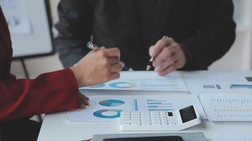 Financial analysts analyze business financial reports on a digital tablet planning investment project during a discussion at a meeting of corporate showing the results of their successful teamwork. video