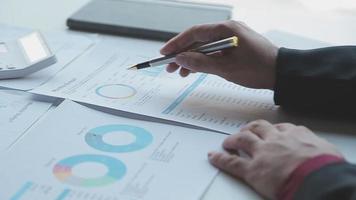 Financial analysts analyze business financial reports on a digital tablet planning investment project during a discussion at a meeting of corporate showing the results of their successful teamwork. video