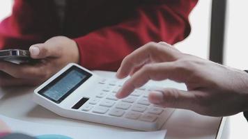 Financial analysts analyze business financial reports on a digital tablet planning investment project during a discussion at a meeting of corporate showing the results of their successful teamwork. video