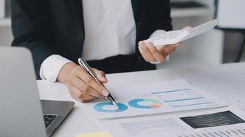 Financial analysts analyze business financial reports on a digital tablet planning investment project during a discussion at a meeting of corporate showing the results of their successful teamwork. video