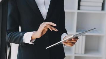 Financial analysts analyze business financial reports on a digital tablet planning investment project during a discussion at a meeting of corporate showing the results of their successful teamwork. video