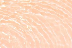 Defocus blurred transparent cream-colored clear calm water surface texture with splashes and bubbles. Trendy abstract nature background. Water waves in sunlight with ivory. Eggshell color water shine photo