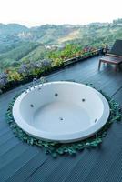 bath tub on balcony with mountain hill background photo