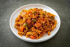 fusilli pasta with ham and tomatoes sauce photo