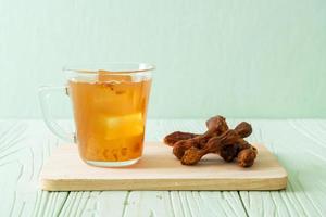 Delicious sweet drink tamarind juice and ice cube photo