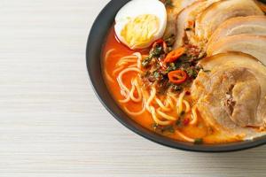 Ramen Noodles Spicy Tomyum Soup with Roast Pork photo
