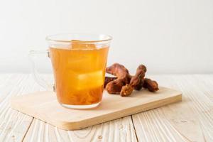 Delicious sweet drink tamarind juice and ice cube photo