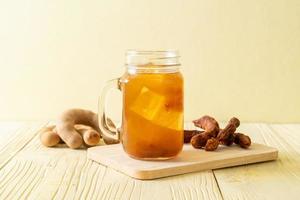 Delicious sweet drink tamarind juice and ice cube photo