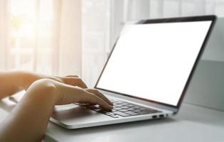 Close up of female man hands using laptop at home office. Concept of searching web, browsing information. soft focus photo