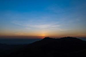 Beautiful sunrise landscape on the mountain of thailand. Golden and blue sky sunrise in the morning. photo