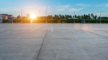 Empty parking lot and blue sky background. Parking outdoor in public park photo