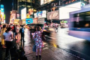 New York City, USA - August 9, 2019-People and tourists stroll among the lights and skyscrapers of Time Square in Manhattan during a summer night photo