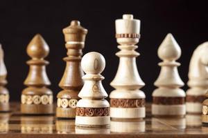 Chess on a dark background. A puzzle game with tricky combinations that requires planning and thinking. photo