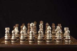 Chess on a dark background. A puzzle game with tricky combinations that requires planning and thinking. photo