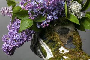 Part of an old sneaker covered with moss and blooming sauerkraut. Shoes made from natural materials. photo